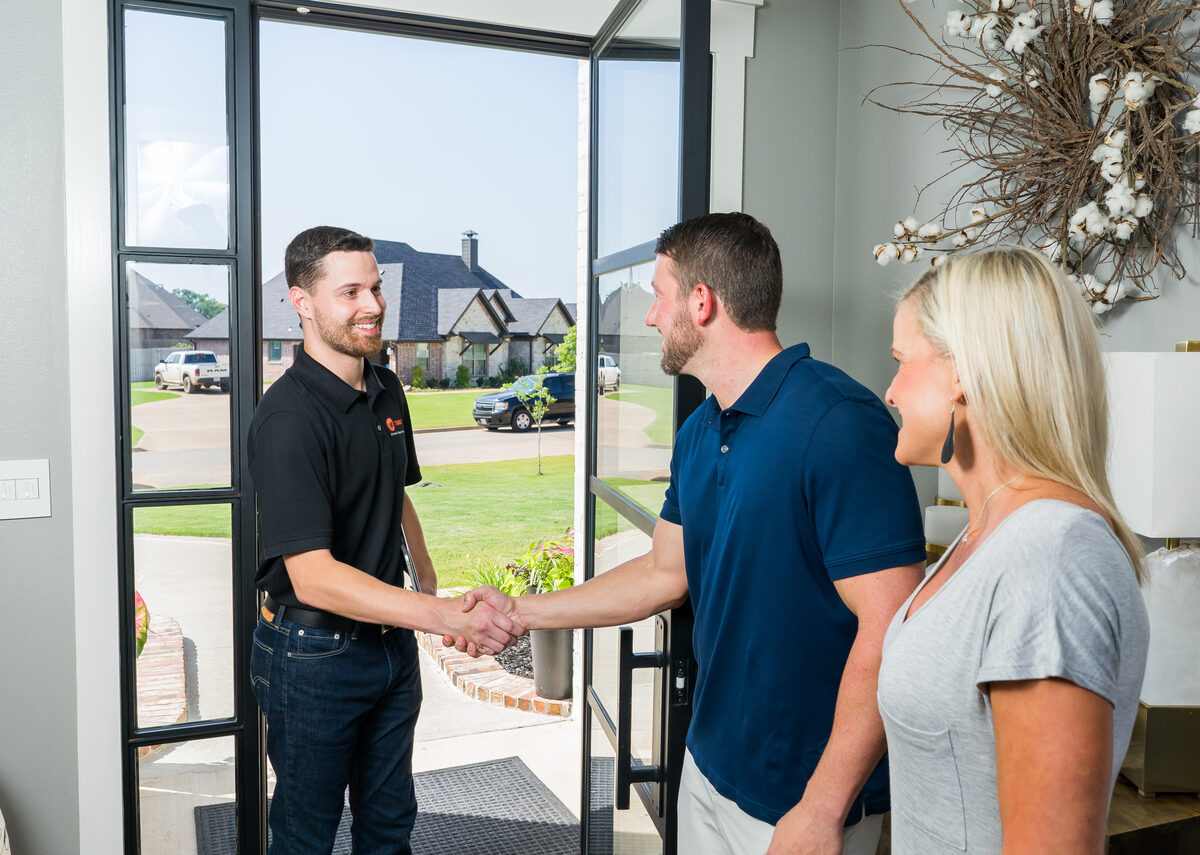 trane hvac tech shaking a mans hand